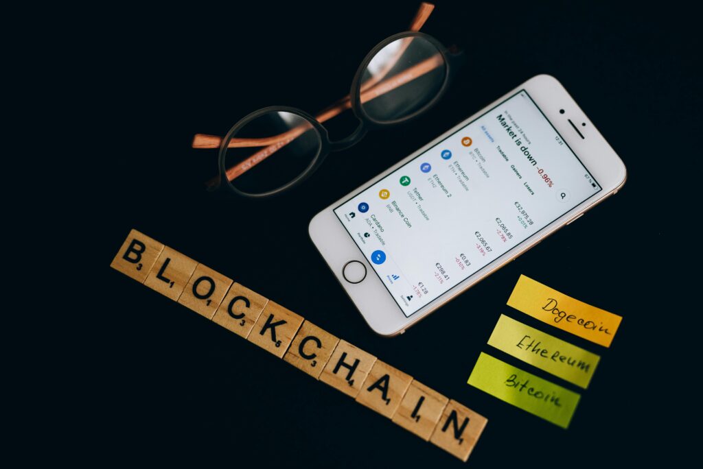About Smartphone displaying cryptocurrency market data alongside blockchain concept elements.